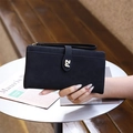 Detail of black matte long wallet with metal PZ logo and wristlet strap held in hand - Black