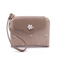 Detailed view of women's short wallet with lychee texture and floral metal clasp - Apricot