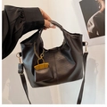 Detail of dark brown pebble leather tote bag with mini pouch and gold chain accent - Brown