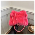 Detail of soft bright pink faux fur shoulder bag texture with slim leather straps - Rose Red