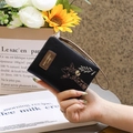 Close-up of black PU leather zipper wallet featuring a cute embroidered giraffe and wristlet - Black