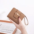 Brown lychee texture short wallet featuring a cream bow buckle and leather wrist strap - Brown