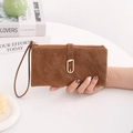 Detail of a brown frosted leather long wallet with gold leaf clasp and wrist strap - Long Style / Brown