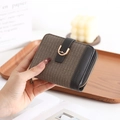 Detail of short fold-over wallet in brown plaid fabric with leather buckle and D-ring - Black and Gray