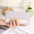 Detail of lavender leather patchwork wallet with cream woven fabric and golden buckle clasp - Purple