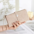 Detail of a pink matte PU leather long wallet with elegant wavy stitching and wrist strap - Apricot