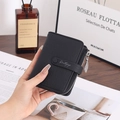 Close-up of black leather wallet with leaf-shaped metal zipper pull and snap closure - Black