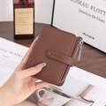 Detailed view of brown lychee grain leather wallet with a gold leaf zipper pendant - Dark Coffee