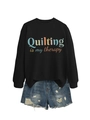 Detail of the high-quality cotton fabric and colorful slogan print on the black sweatshirt - Black