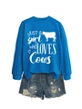 Flat lay of royal blue cow print sweatshirt set with distressed denim shorts - Lake Blue (White Font)