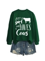 Flat lay of a green sweatshirt with cow print and distressed denim shorts ensemble - Dark Green (White Font)