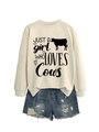 Detail of off-white crewneck sweatshirt with cow print and distressed blue denim shorts - Sand (Black Font)