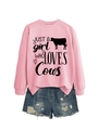 Flat lay detail of pink sweatshirt with cow slogan and distressed blue denim shorts - Pink (Black Font)