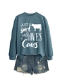 Detail of cow-themed graphic print on teal sweatshirt with distressed denim shorts - Blue (White Font)