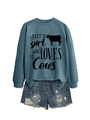 Detail of blue cows print sweatshirt paired with distressed denim shorts on white background - Blue (Black Font)