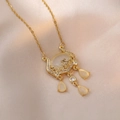 Golden Ruyi lock necklace with cat eye stone and teardrop charms on silk background - Cat's Eye Ruyi Lock (X0778) / Gold