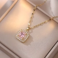 Macro shot of gold square necklace pendant with pink stone and halo crystal setting - X1153 - Gold Pink
