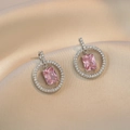 Elegant pink zircon stud earrings with silver-toned floral halo on champagne silk fabric - Pink Zircon Earrings