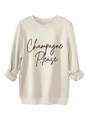 Detailansicht des Champagne Please Aufdrucks und Rippbündchen am beigen Fleece-Sweatshirt - S / Sandfarben