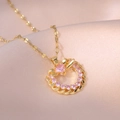 Elegant gold heart pendant necklace with pink crystals on pink satin background - Pink Heart Necklace (Gold Color)