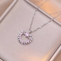 Macro shot of silver heart necklace with pink gemstones and sparkling zircon pavé - Pink Heart Necklace (Silver Color)