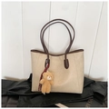Detail of large beige tote bag with brown handles and a cute plush bear charm - White with Pendant