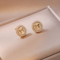 Elegant gold bow earrings with mini white pearls on a velvet jewelry display box - Shell Pearl Earrings (E0726)