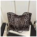 Detail of high-capacity leopard print canvas tote bag with long shoulder straps - Brown