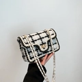 Elegant black and white tweed crossbody bag with golden chain strap and woven trim - Black