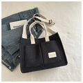 Deep grey canvas tote bag with cream straps and adjustable shoulder strap on white fabric - Black