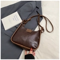 Detail of vintage brown leather underarm bag showing adjustable strap and fashion logo - No Pendant / Brown