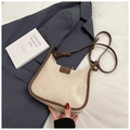 Detail of beige hobo shoulder bag with brown trim and FASHION logo on a grey blazer - No Pendant / White
