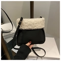 Close-up of contrast faux shearling and black suede bucket bag with gold buckle detail - Black