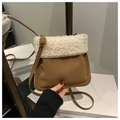 Detail of faux shearling bucket bag with brown leather strap and gold buckle adjustment - Brown