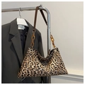 Detail showing amber acrylic chain links and brown leather strap on leopard print tote - Brown