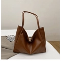 Close-up of a large brown faux leather tote bag showing the magnetic buckle and texture - Brown