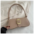 Close-up of nude pink leather baguette bag featuring large oval gold buckle detail - Khaki