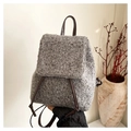 Detail of wool texture and brown leather strap on a minimalist grey bucket backpack - Gray