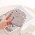 Detail of grey textured short wallet featuring golden zipper and matching wrist strap - Purple Grey