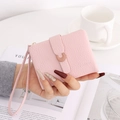 Pink lychee grain leather short wallet with metal buckle and wrist strap detail - Pink