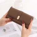 Detailed view of a brown pebbled leather long wallet with gold LUCKY metal clasp - Brown
