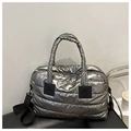 Close-up of quilted silver metallic tote bag with horizontal padding and black straps - Silver Gray