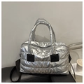 Detail of silver quilted puffer bag with waterproof metallic finish and black strap - Silver
