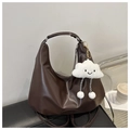 Detail of dark brown faux leather hobo bag featuring a cute white cloud plush charm - With Pendant / Brown