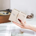Close-up of beige wallet featuring elegant leaf embroidery and a gold leaf-shaped clasp - Apricot