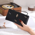 Detail of long black leather wallet featuring triple-color leaf embroidery and wrist strap - Black