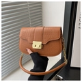 Close-up of brown crocodile texture leather and luxury gold clasp on shoulder bag - Brown