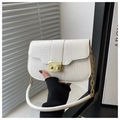 Detailed shot of white croc-embossed leather handbag with a gold square rotary lock - White