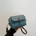 Blue lychee leather crossbody bag with brown shoulder strap and golden metal hooks - Blue