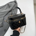 Quilted black leather handbag with gold camellia accent and chain shoulder strap - Black